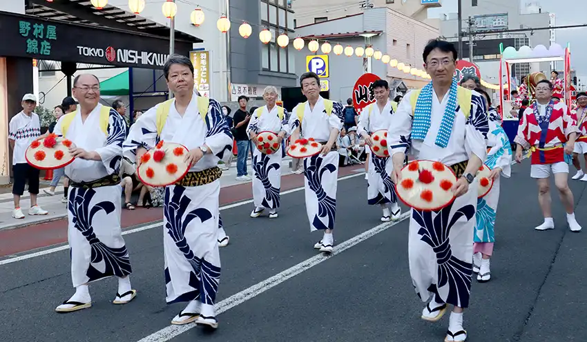 パレードの先頭で踊る佐藤頭取（前列左から2人目、8月5日、山形市、山形銀提供）